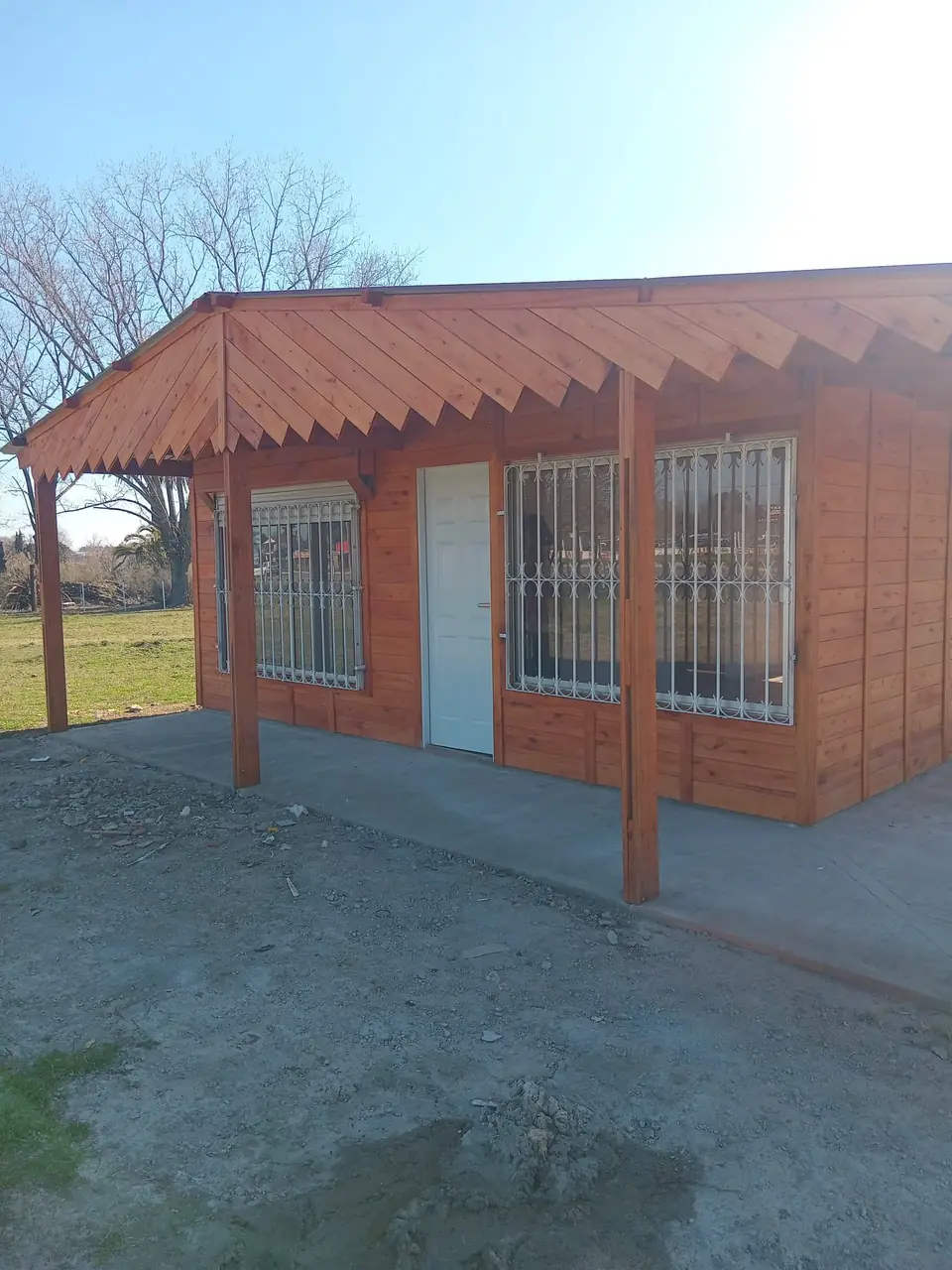Frente de la vivienda terminada, con la galería y la puerta de entrada